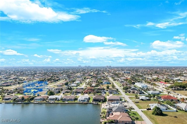 drone / aerial view featuring a residential view and a water view