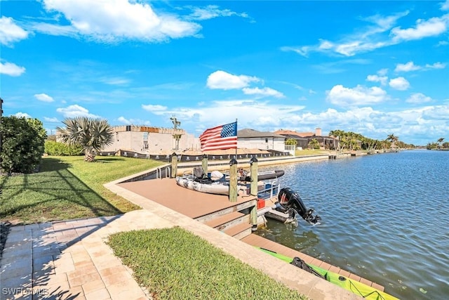 view of dock featuring a lawn and a water view