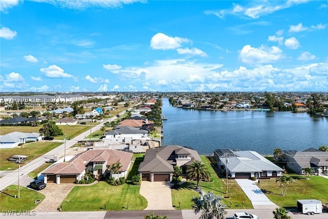 drone / aerial view with a residential view and a water view