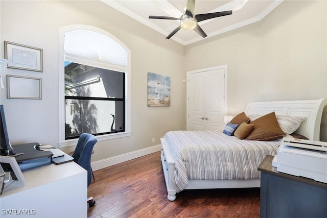 bedroom with baseboards, a ceiling fan, dark wood finished floors, and crown molding