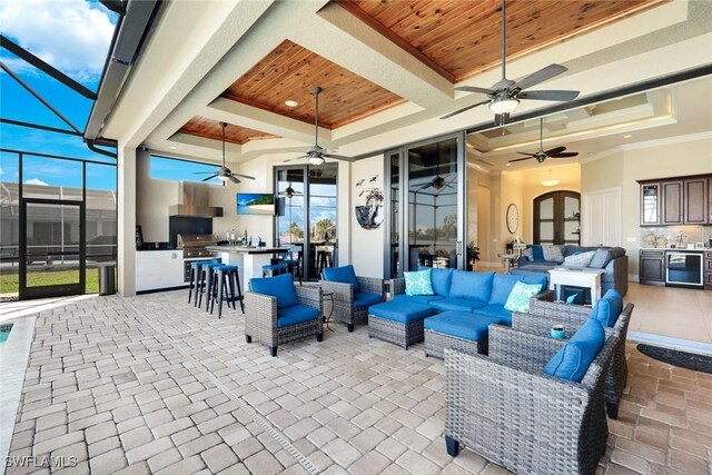 view of patio / terrace featuring outdoor wet bar, area for grilling, wine cooler, outdoor lounge area, and a lanai