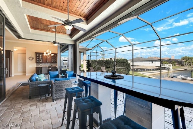 view of patio / terrace featuring a lanai, an outdoor hangout area, outdoor dry bar, and a ceiling fan