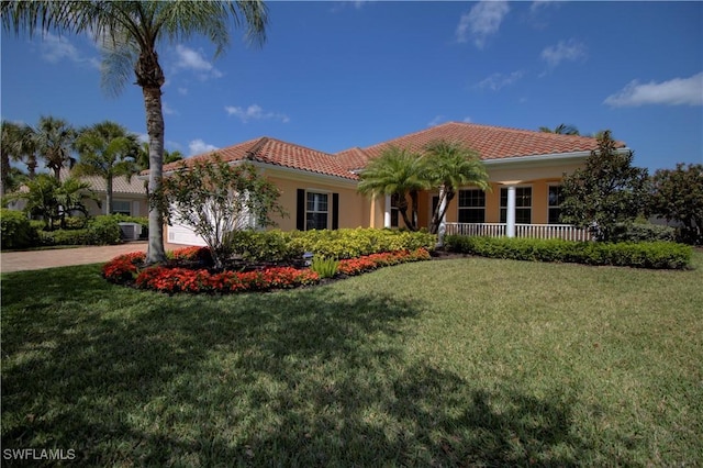 view of front of home with an attached garage, a tile roof, driveway, and a front yard