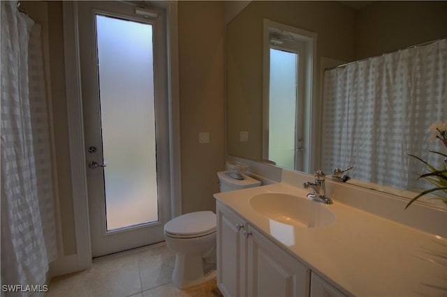 full bathroom featuring tile patterned flooring, toilet, and vanity