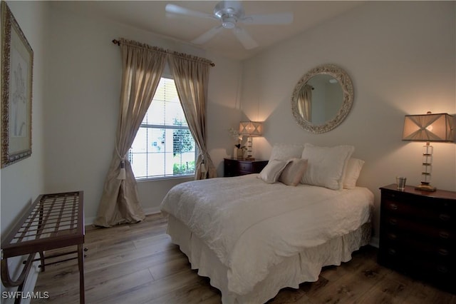 bedroom with wood finished floors, baseboards, and ceiling fan