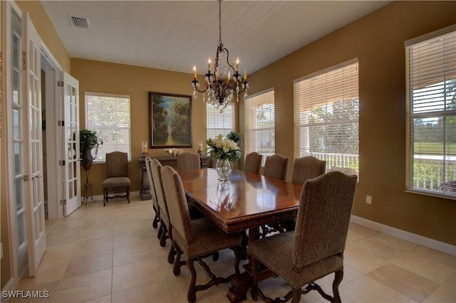 dining space featuring visible vents, french doors, light tile patterned flooring, baseboards, and a chandelier