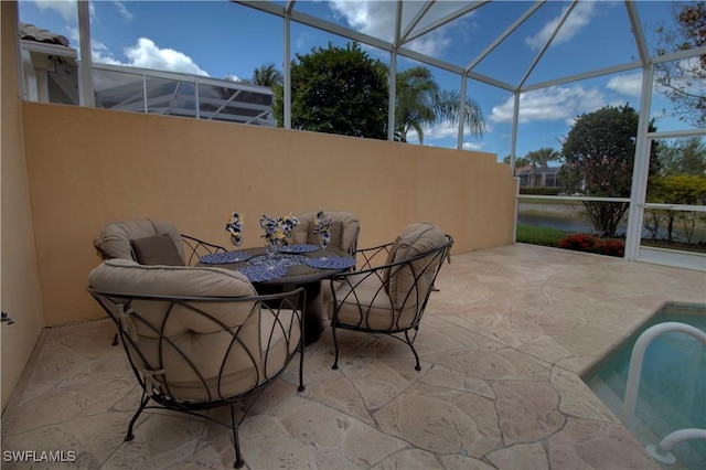 view of patio with a lanai and outdoor dining space