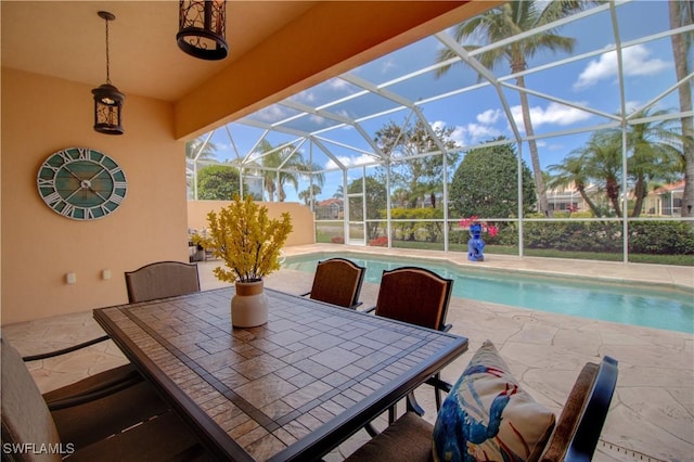 view of patio with a lanai, an outdoor pool, and outdoor dining area