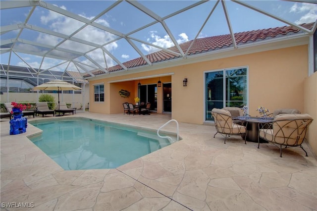 view of swimming pool with a patio area, a fenced in pool, a lanai, and outdoor dining area