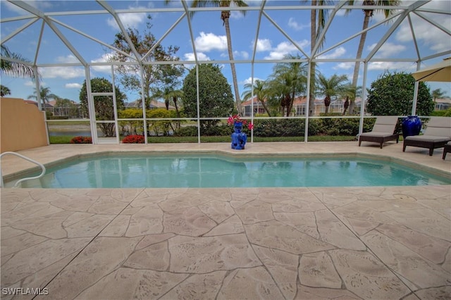 outdoor pool featuring a patio area and glass enclosure