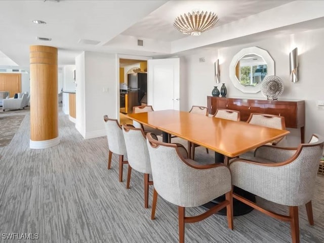 dining room with decorative columns, baseboards, and visible vents