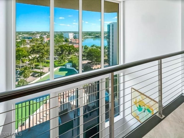 balcony with a water view and a city view