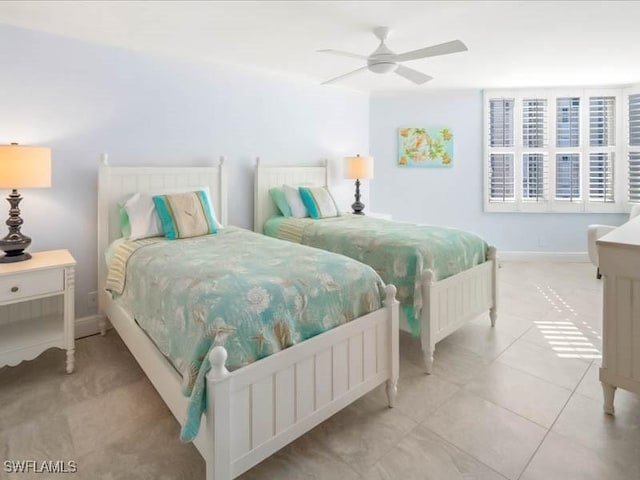 bedroom with light tile patterned floors, baseboards, and a ceiling fan