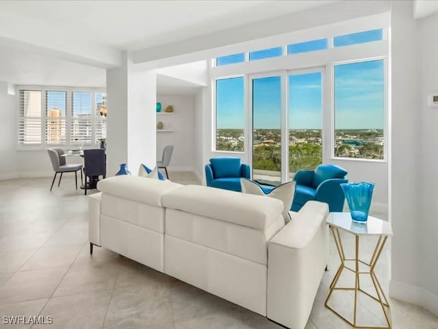 living room with light tile patterned floors and baseboards