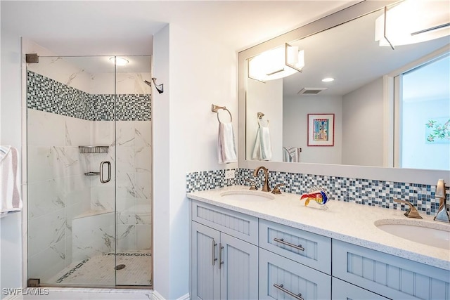 bathroom featuring decorative backsplash, visible vents, and a sink