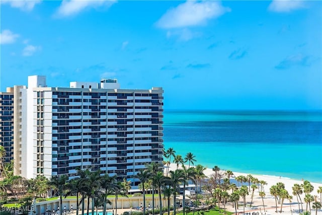 view of building exterior with a view of the beach and a water view
