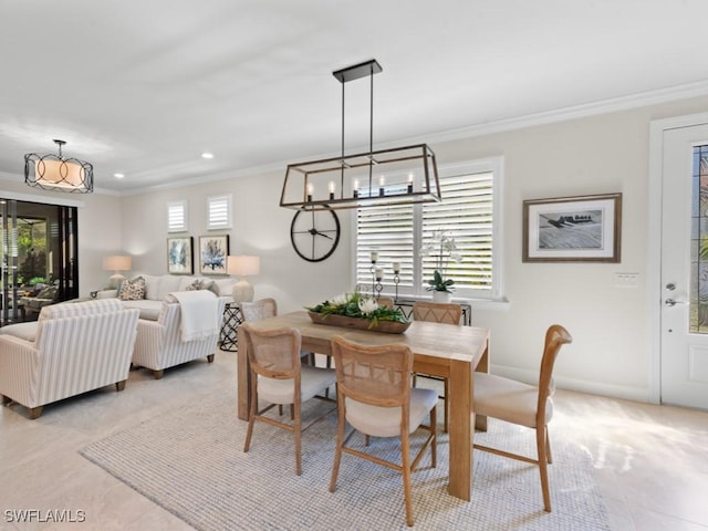 dining room featuring an inviting chandelier, light tile patterned floors, and ornamental molding