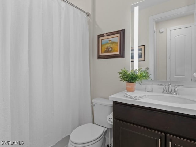 full bathroom with toilet and vanity