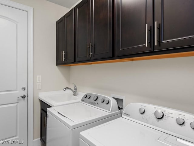 washroom featuring a sink, cabinet space, and washing machine and dryer