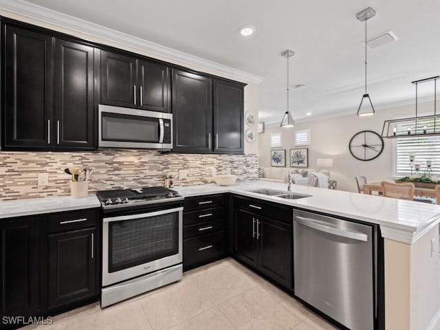 kitchen featuring a sink, dark cabinetry, and stainless steel appliances