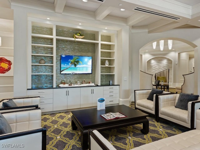 living room with visible vents, beam ceiling, built in shelves, coffered ceiling, and arched walkways