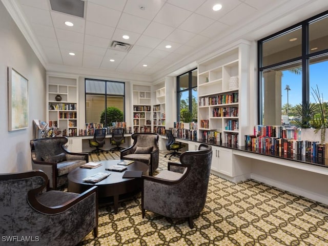 living area featuring recessed lighting, visible vents, built in features, and ornamental molding