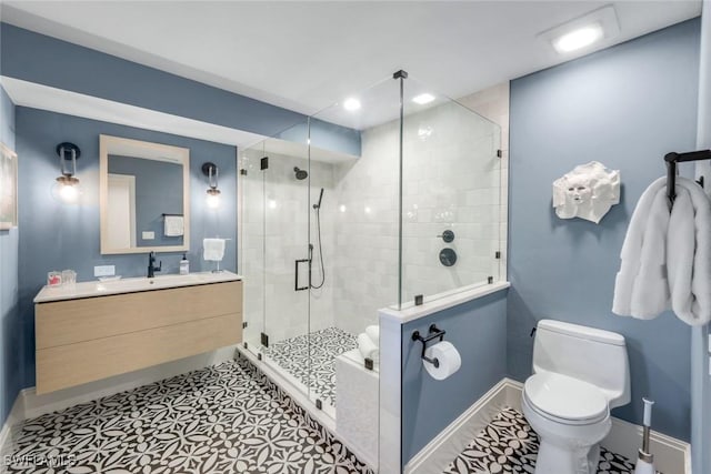 bathroom featuring vanity, baseboards, recessed lighting, a stall shower, and toilet