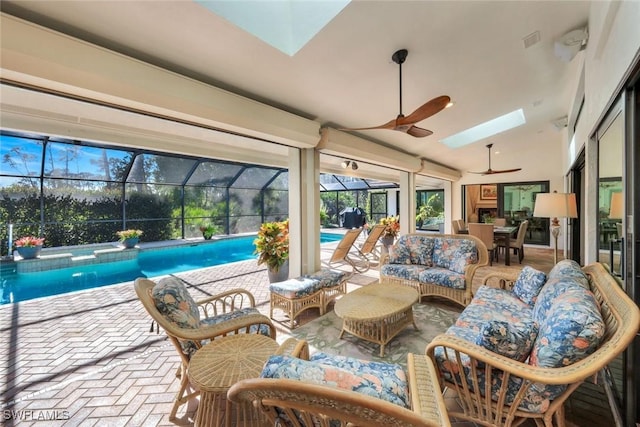 sunroom with a swimming pool, visible vents, lofted ceiling with skylight, and a ceiling fan