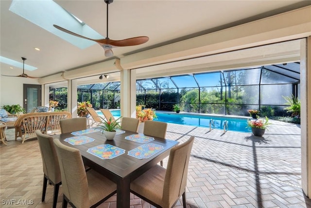 sunroom / solarium featuring a pool and a ceiling fan