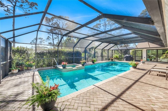 view of swimming pool with a patio area, a lanai, and a pool with connected hot tub