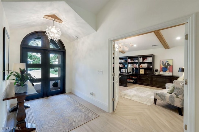 entrance foyer with visible vents, baseboards, vaulted ceiling, french doors, and an inviting chandelier