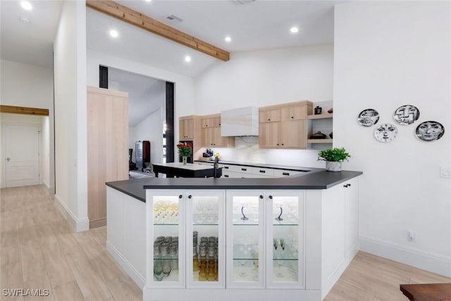 kitchen featuring dark countertops, visible vents, light brown cabinets, beamed ceiling, and open shelves