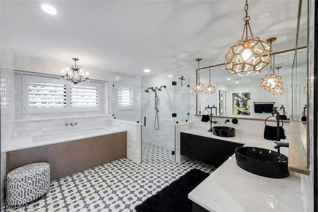 bathroom featuring double vanity, recessed lighting, a stall shower, a sink, and a garden tub