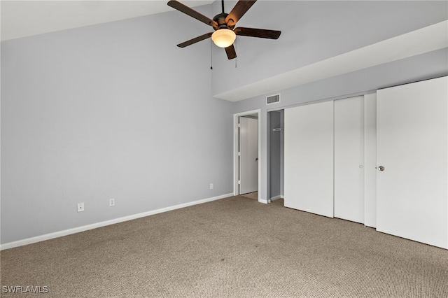 unfurnished bedroom featuring visible vents, a closet, carpet floors, baseboards, and ceiling fan