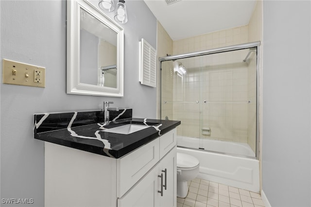 full bath featuring visible vents, toilet, tile patterned flooring, bath / shower combo with glass door, and vanity