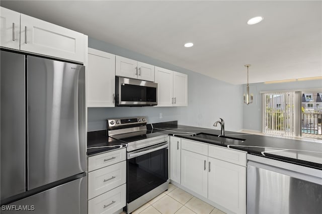 kitchen featuring a sink, dark countertops, white cabinetry, stainless steel appliances, and light tile patterned flooring