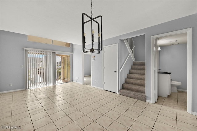 interior space featuring tile patterned flooring, stairway, and baseboards