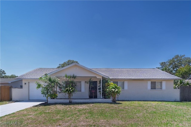 ranch-style house with brick siding, fence, a front yard, driveway, and an attached garage