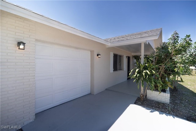 exterior space featuring a garage and stucco siding