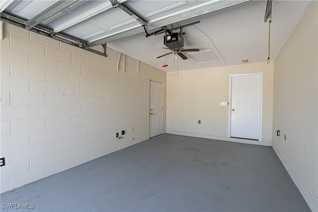 garage with a garage door opener and baseboards