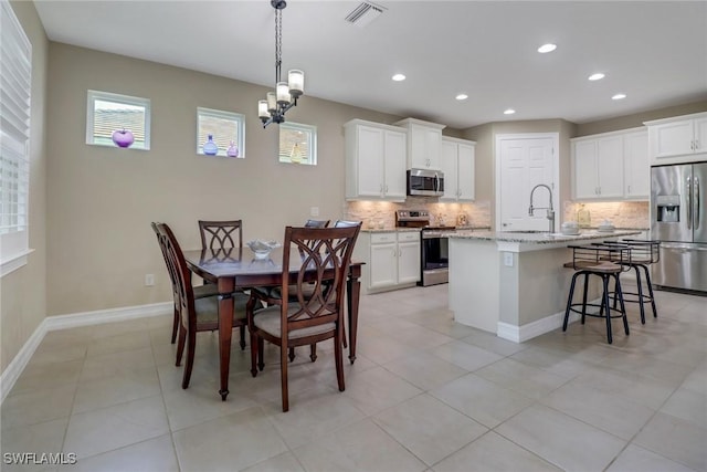 dining space featuring visible vents, baseboards, a chandelier, light tile patterned floors, and recessed lighting