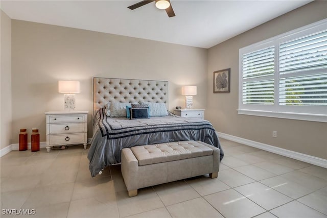 bedroom with light tile patterned flooring, ceiling fan, and baseboards