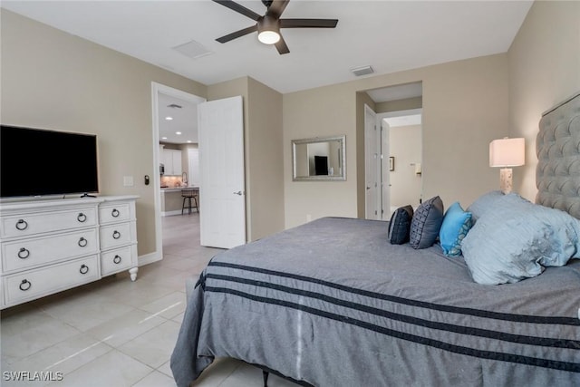 bedroom featuring light tile patterned floors, visible vents, baseboards, and a ceiling fan