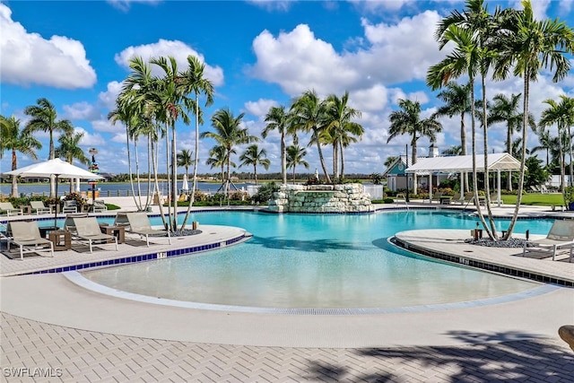 community pool with a gazebo and a patio area