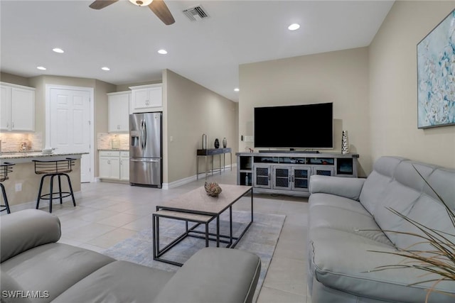 living room featuring light tile patterned flooring, recessed lighting, visible vents, and ceiling fan