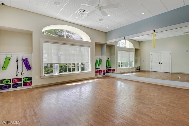 interior space featuring visible vents, a paneled ceiling, ceiling fan, and wood finished floors