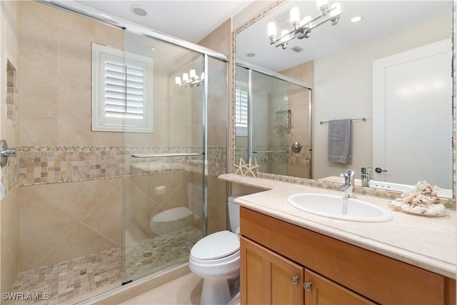 bathroom with vanity, toilet, and a stall shower