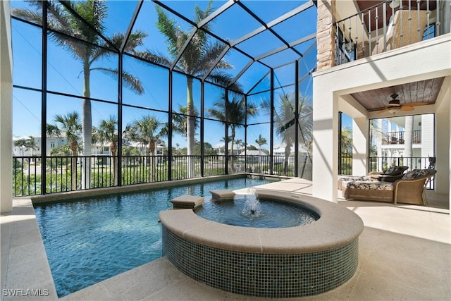 view of pool with a patio area, glass enclosure, a pool with connected hot tub, and ceiling fan