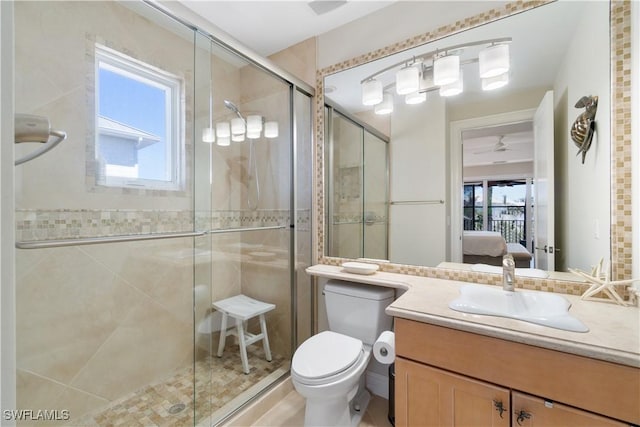 bathroom with vanity, plenty of natural light, a stall shower, and ensuite bathroom