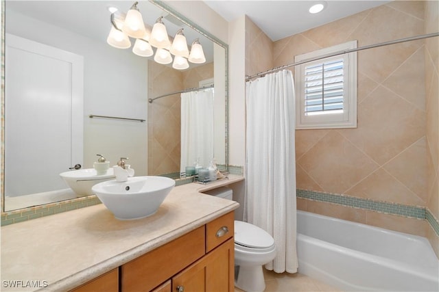 bathroom with vanity, toilet, and shower / bath combo with shower curtain